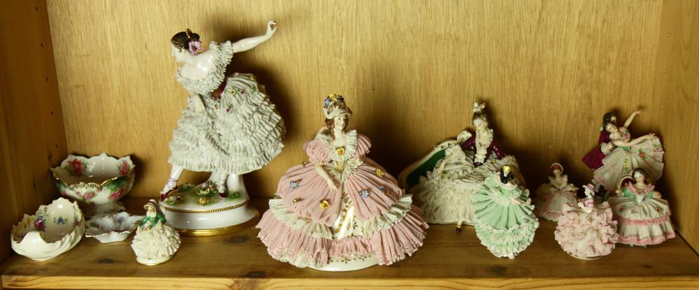 A shelf of mostly crinoline figural sculptures (1 of 1)