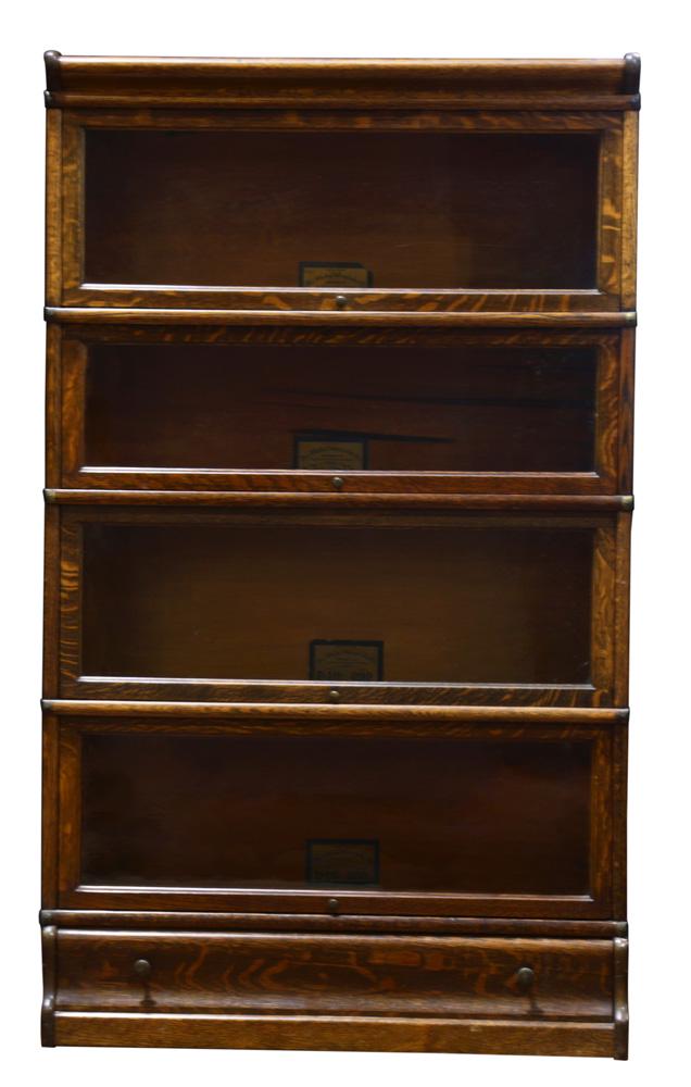 An Arts and Crafts Globe Wernicke stackable quartersawn: An Arts and Crafts Globe Wernicke stackable quartersawn oak barrister bookcase, executed in four parts, each having a hinged glazed door and resting on a single drawer molded base, 57.5"h x 34"w x 12"