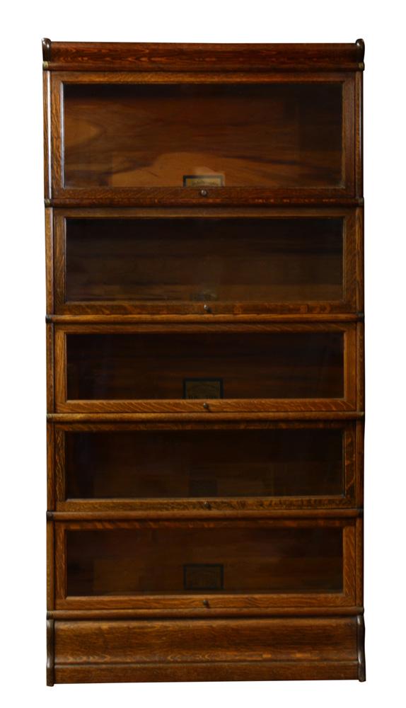 An Arts and Crafts Globe Wernicke quartersawn oak: An Arts and Crafts Globe Wernicke quartersawn oak stackable barrister bookcase, executed in five parts, each having a hinged and glazed door resting on a molded base, 68"h x 34"w x 12"d