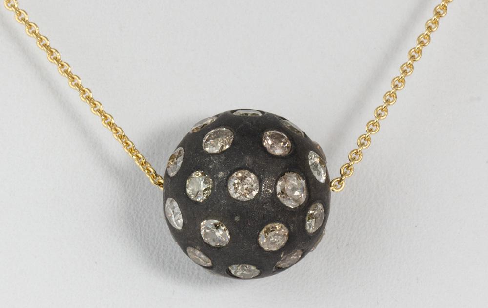 Diamond, blackened silver, 18k yellow gold necklace: Diamond, blackened silver, 18k yellow gold necklace Featuring (36) full-cut diamonds, weighing a total of approximately 2.00 cts., set in a black and silver ball form, slide pendant, measuring approxi