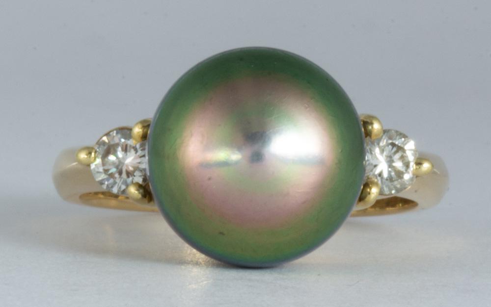 Tahitian cultured pearl, diamond, 18k yellow gold ring: Tahitian cultured pearl, diamond, 18k yellow gold ring Featuring (1) grey cultured pearl, measuring approximately 9.7 mm, flanked by (2) full-cut diamonds, weighing a total of approximately 0.25 ct., 