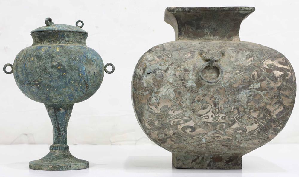 Two Chinese Archaistic Bronze Ritual Vessels: (Lot of 2)Two archaistic bronze ritual vessels, the first, a bronze "dou" vessel and cover, the second of a compressed ovoid body supporting the twin Taotie-head ring handles, incised decorative patte