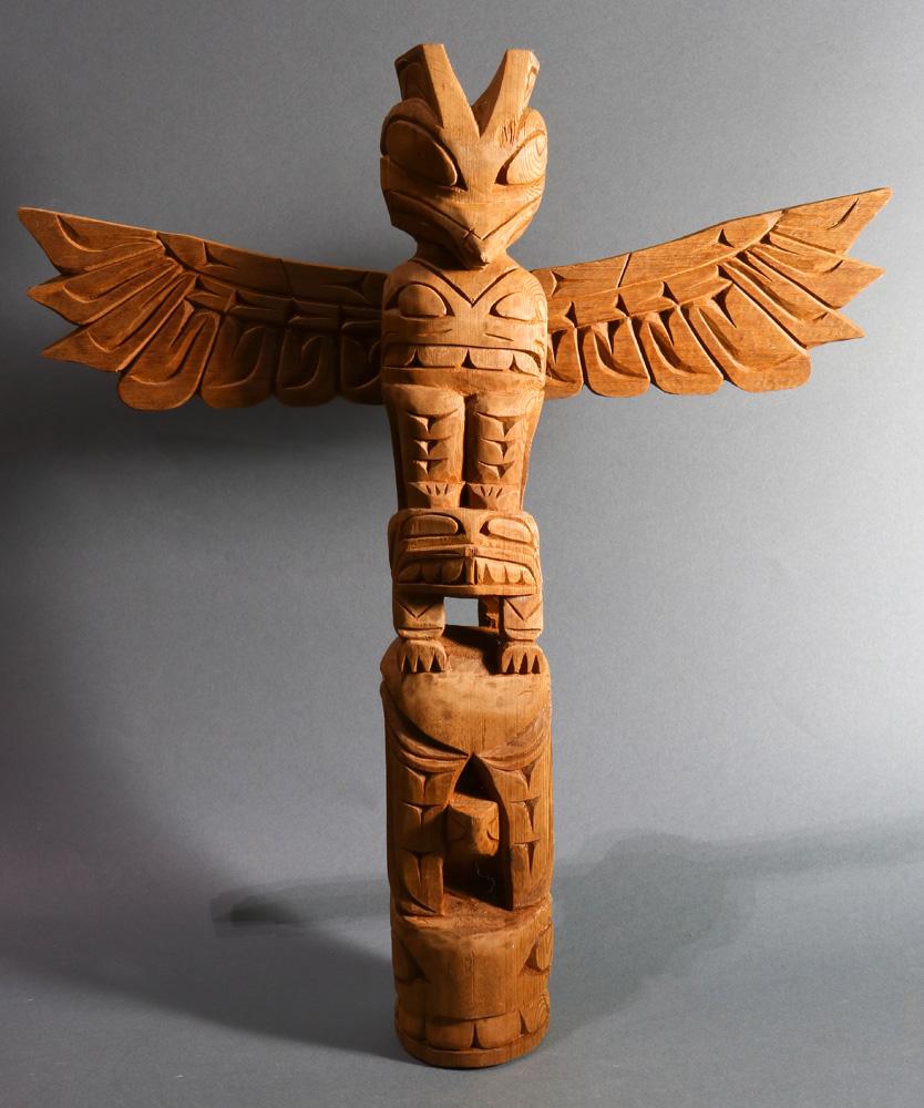 Pacific Northwest Coast Kwakiutl cedar totem pole: A Pacific Northwest Coast Kwakiutl cedar totem pole, 20th Century, depicting a raven and turtle, the base figure depicting a zoomorphic figure playfully turned backward with head between its legs, 18.