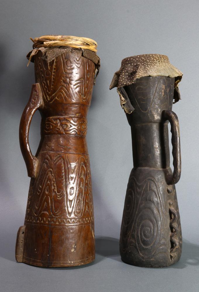 (lot of 2) A grouping of Papua New Guinea drums: (lot of 2) A grouping of Papua New Guinea drums, the brown and taller one an especially fine example, both showing handling and use but in good condition and with intact monitor-lizard skins, largest 