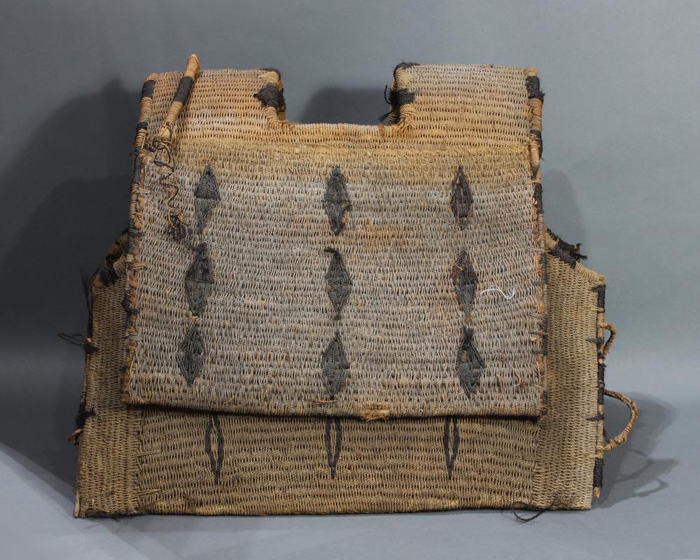 A Micronesian warrior: A Micronesian warrior's armor of woven coconut fiber, Gilbert Islands, late 19th century, significantly used, finely executed with woven geometric patterns, part of a suit, 22.5"h x 25"w; Provenance: 