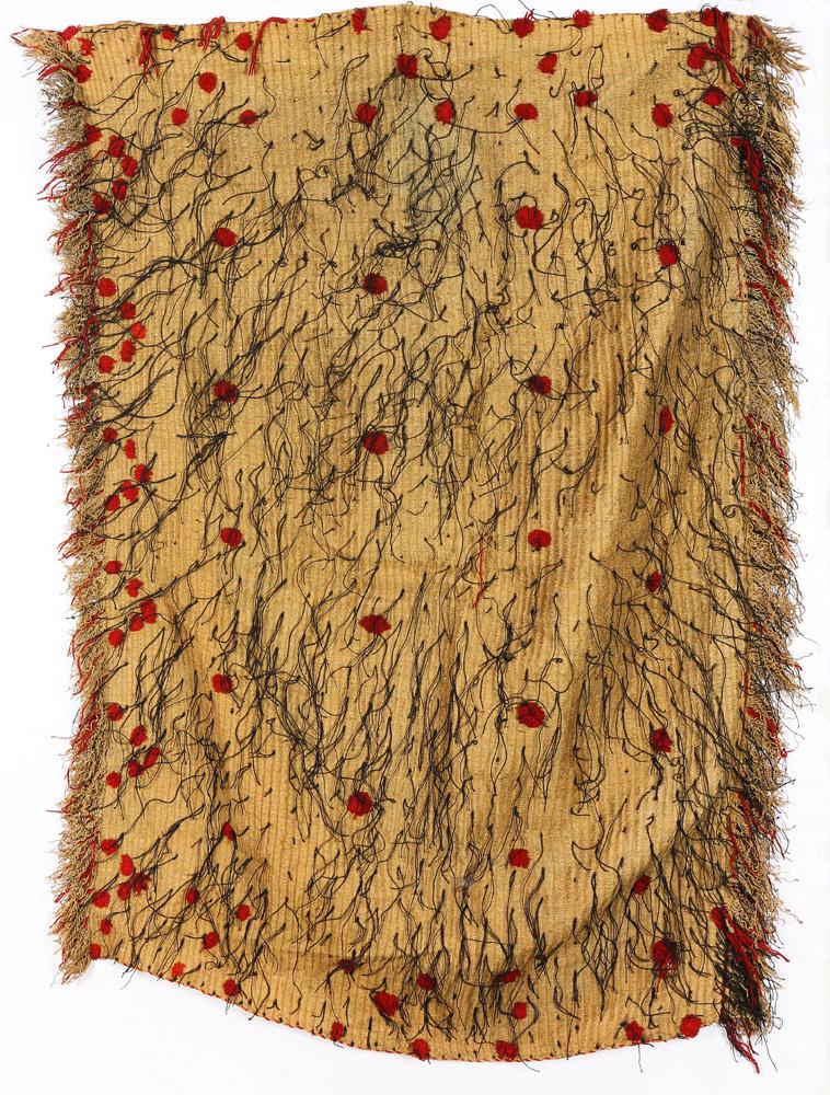A Maori Flax Dance Skirt: A Fine Maori woven flax dance skirt, New Zealand, accented with red and black stiching, 51"h x 34"w Provenance: Richard I.M. Kelton Collection, Marina del Rey, California