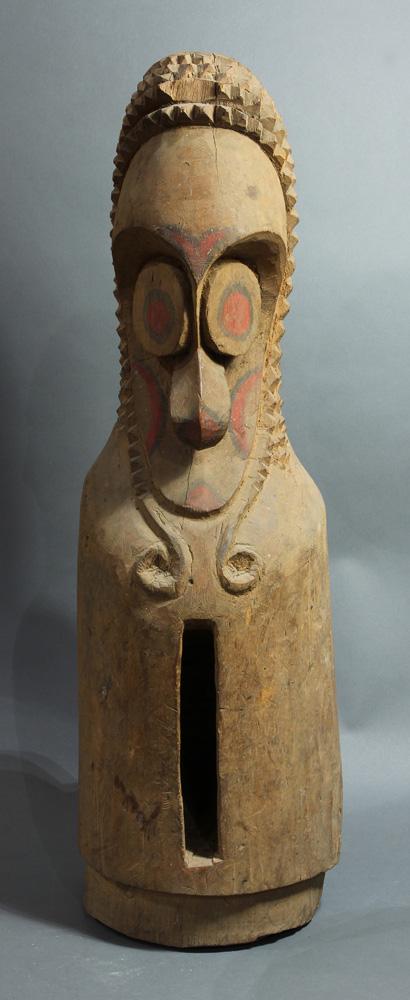 A Namba people, Malekula Vanuatu small figural slit: A Vanuatu small figural slit drum, A Namba people, Malekula, with oversized forehead and chip-Carved multiple rows, traces of red pigment at eyes and cheeks, 31"; Provenance: Richard I.M. Kelton Colle