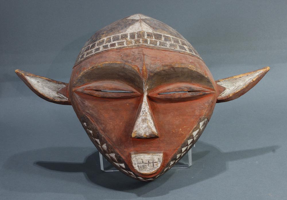 An African Eastern Pende mask: An African Eastern Pende mask, Democratic Republic of the Congo, of diamond shape with red, wide and pointed ears, 11"h x 16"w; Provenance: Richard I.M. Kelton Collection, Marina del Rey, California