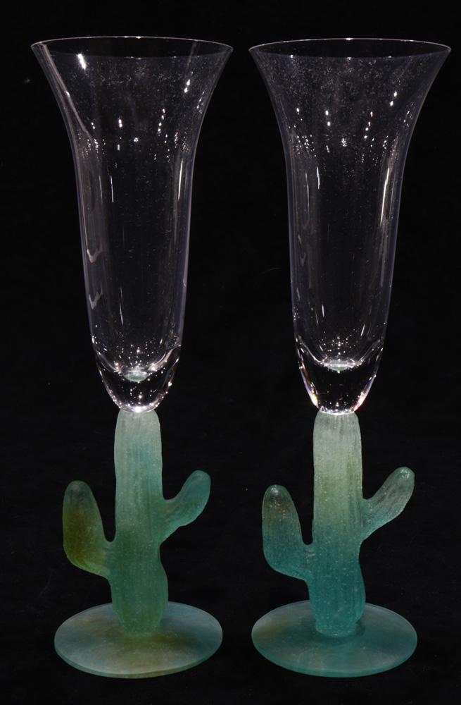 A pair of Daum "Cactus" pate de verre glass and crystal: A pair of Daum "Cactus" pate de verre glass and crystal champagne flutes, each having a clear bowl above the cactus form standard, etched signature to underside, 9.5"h
