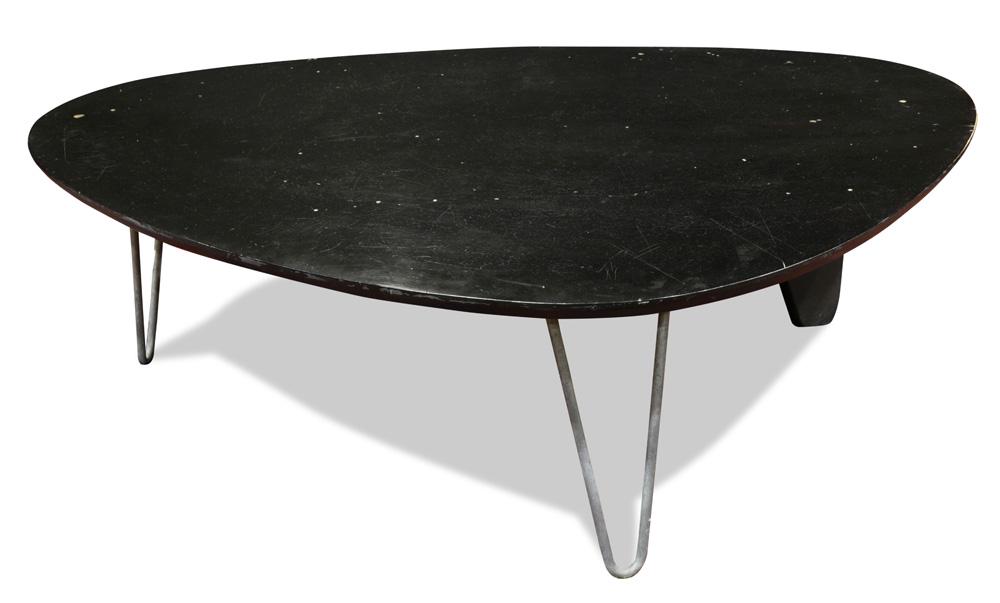 An Isamu Noguchi for Herman Miller Rudder coffee table,: Isamu Noguchi for Herman Miller Rudder coffee table, Model IN-52, circa 1944, having a shaped ebonized top, above two hair pin chrome legs, and one blade shaped leg, 15.5"h x 50"w x 37"d Provenance: B
