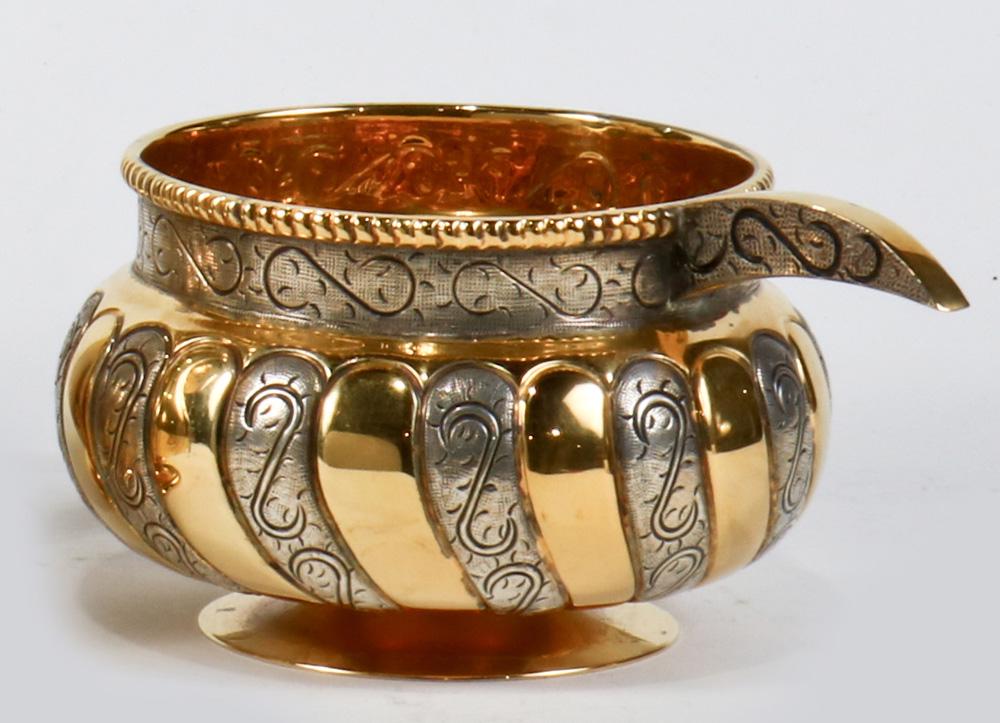A Mexican Tane Orfebres sterling silver gilt bowl: A Mexican Tane Orfebres sterling silver gilt bowl, Mexican City, fashioned in the Conquistador style, the globular form footed bowl with a gadroon pattern with vertical gilt wash ribbing, alternating 