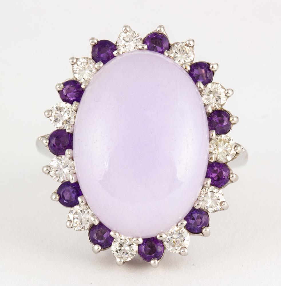 Jadeite, amethyst, diamond and 14k white gold ring: Jadeite, amethyst, diamond and 14k white gold ring Centering (1) oval lavender jadeite cabochon, measuring approximately 19.0 X 13.9 X 6.2 mm, surrounded by (11) round-cut amethysts, weighing a total 
