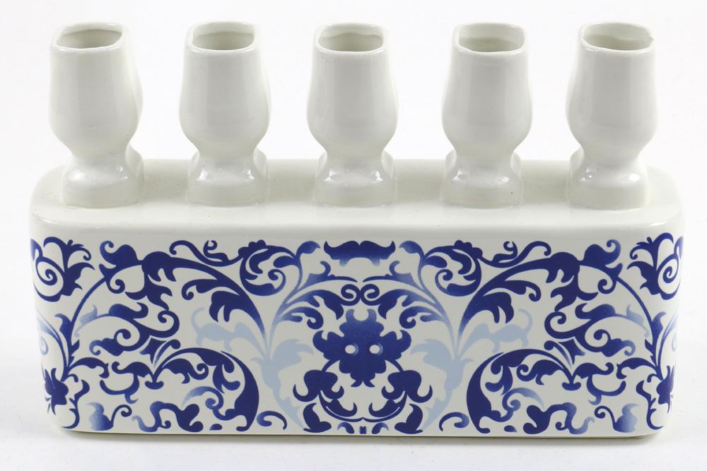 Marcel Wanders Randstad candle holder or flower vase: Marcel Wanders Randstad candle holder or flower vase, having five sections above a foliate blue decorated base, 7"h x 10.5"w