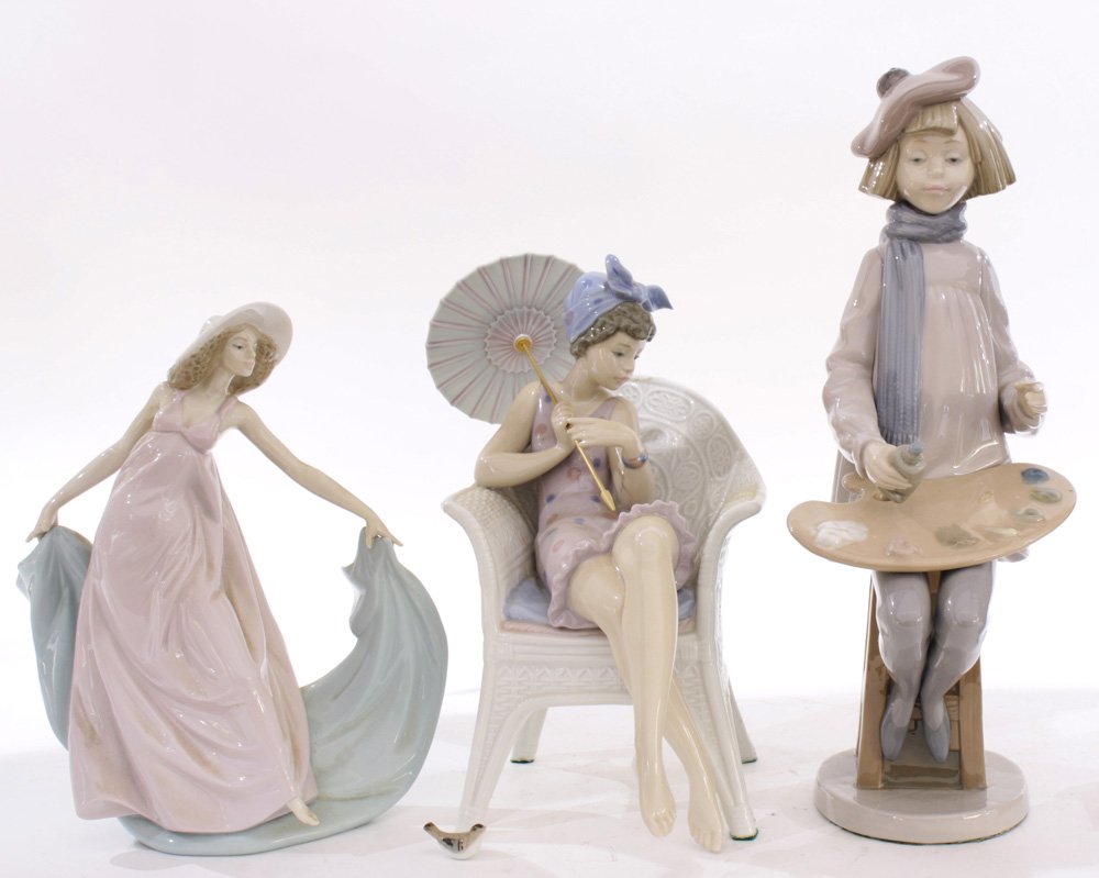 Group of Lladro figural sculptures of ladies: (lot of 3) Group of Lladro figural sculptures of ladies, one depicting a painter, another of a seated figure of lady with umbrella, and the last a girl with hat, largest: 13.5"h