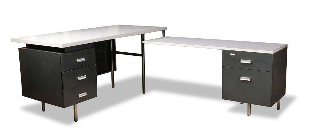 A George Nelson for Herman Miller "Modern Management": George Nelson for Herman Miller "Modern Management" desk, 1953, having a l-form, with a grey laminate top, one section having three drawers with chrome pulls, the other with two drawers, 30"h x 60"w x