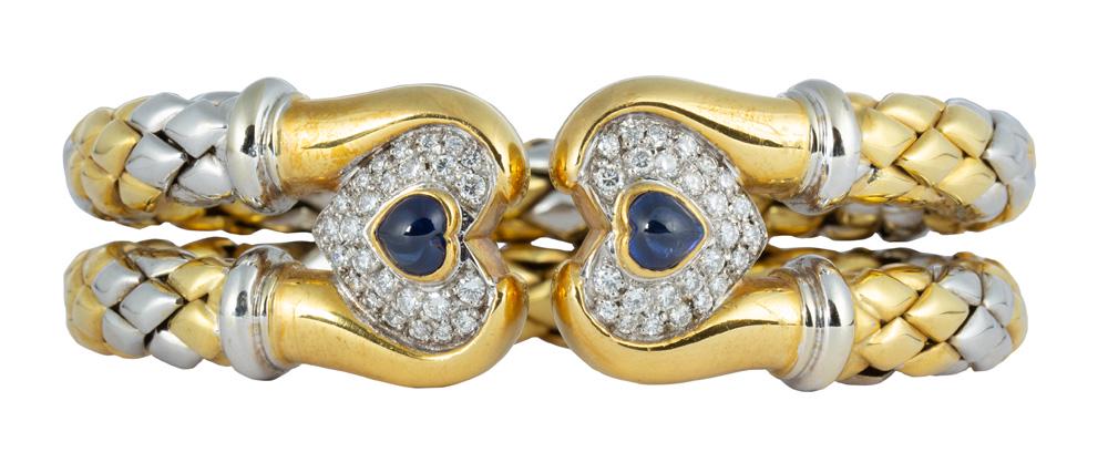 Chimento sapphire, diamond and 18k white and yellow: Chimento sapphire, diamond and 18k white and yellow gold bracelet Featuring (2) heart-shape sapphire cabochons, measuring approximately 5.85 X 5.65 mm, accented by (52) full-cut diamonds, weighing a t