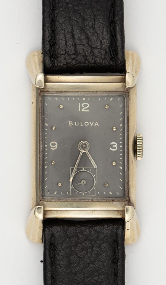 Bulova white gold wristwatch: Bulova white gold wristwatch Dial: rectangular, grey, applied dot and white Arabic numeral hour markers, center white minutes track, baton hands, sunken subsidiary seonds dial at 6:00, Bulova Movement