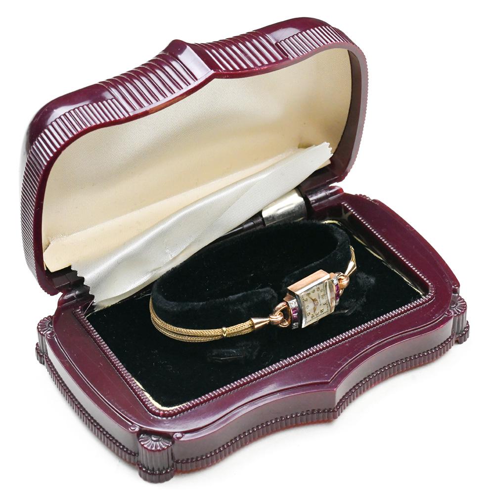 (Lot of 2) Lady's ruby, diamond, 14k rose gold: (Lot of 2) Lady's ruby, diamond, 14k rose gold wristwatch Dial: square, off white, applied Arabic numeral hour markers, black outer minutes square, gold tone dauphine hands, Longines, Swiss Movement: 