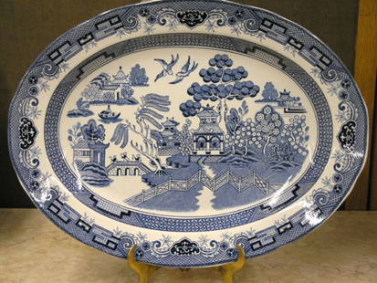 Two Blue Willow Platters: Two blue and white Blue Willow pattern platters, one oval, one rectangular, approximately 18''l x 14''w
