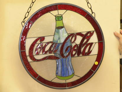 Coke round window: Round stained glass window with central reserve having the Coca Cola logo