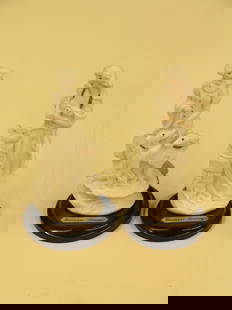 Guiseppe Armani female figurals: Pair of G. Armani bisque porcelain figural groups, one depicting a Woman with doves, the other depicting a woman with dogs, approx 5''h,