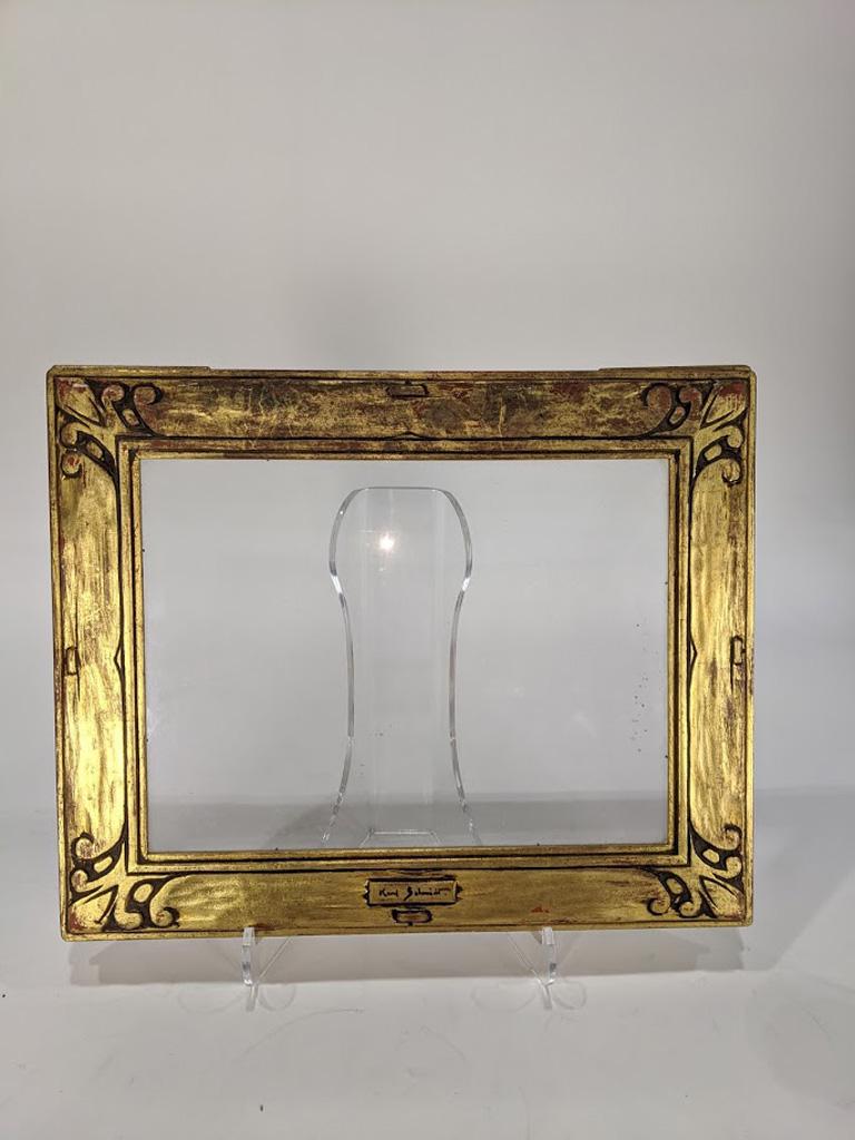 Hand-carved arts and crafts frame, Karl Schmidt: A hand carved And Crafts frame executed by Karl Schmidt (American 1890-1962), signed on central plaque, overall 13"h x 15.5"w rabbet 9"h x 12"w Provenance: Sale to Benefit the Oakland Museum of Califo