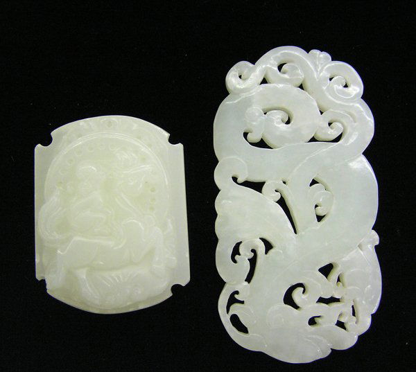 Chinese Jade Belt Buckle/Plaque: (lot of 2) Chinese jade ornaments, the first a greenish-white hue belt buckle carved in relief with a monkey riding on a horse; the second a reticulated plaque of greenish-white matrix, featuring conf