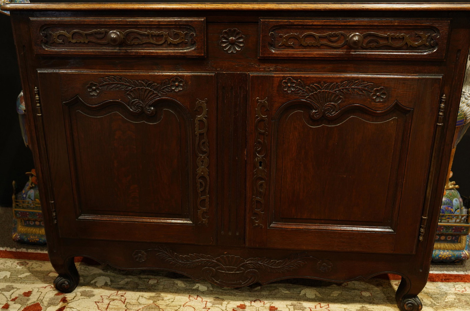 A Louis XV/VI Transitional oak buffet, 18th century: Louis XV/VI Transitional oak buffet, 18th century, having a rectangular top, above two drawers continuing to two paneled doors and rising on short cabriole legs, 38"h x 51"w x 22"d Provenance: Estate 