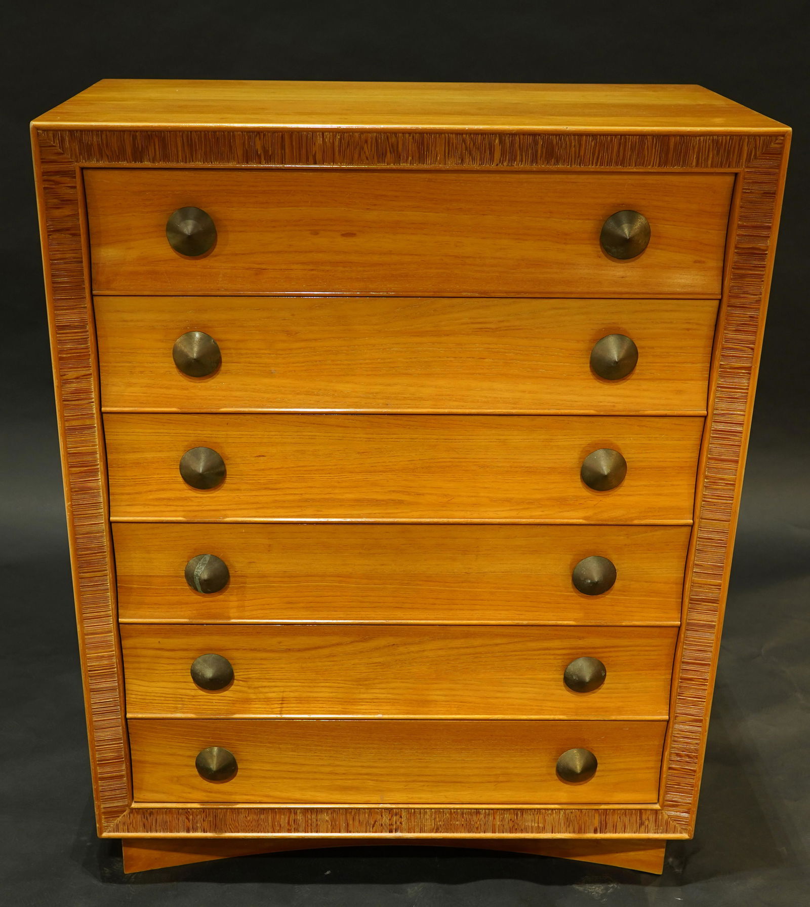 A Paul Frankl for Brown Saltman limed mahogany tall: Paul Frankl for Brown Saltman limed mahogany tall chest, having a rectangular top above six drawers with original conical pulls, accented with decorative carved trim around the edge, above a concave b