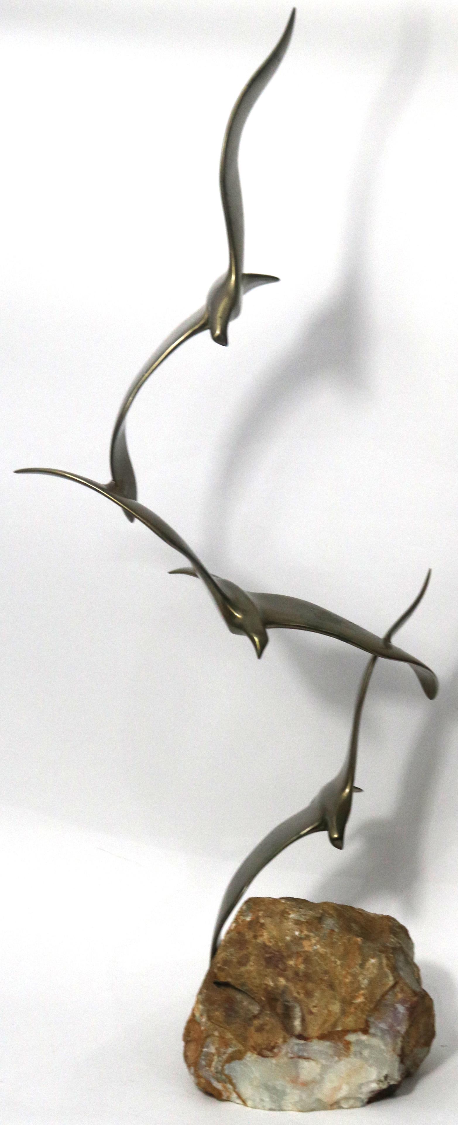 Curtis Jere Birds in flight sculpture: Curtis Jere Birds in flight sculpture, rising on a stone base, signed, 33"h