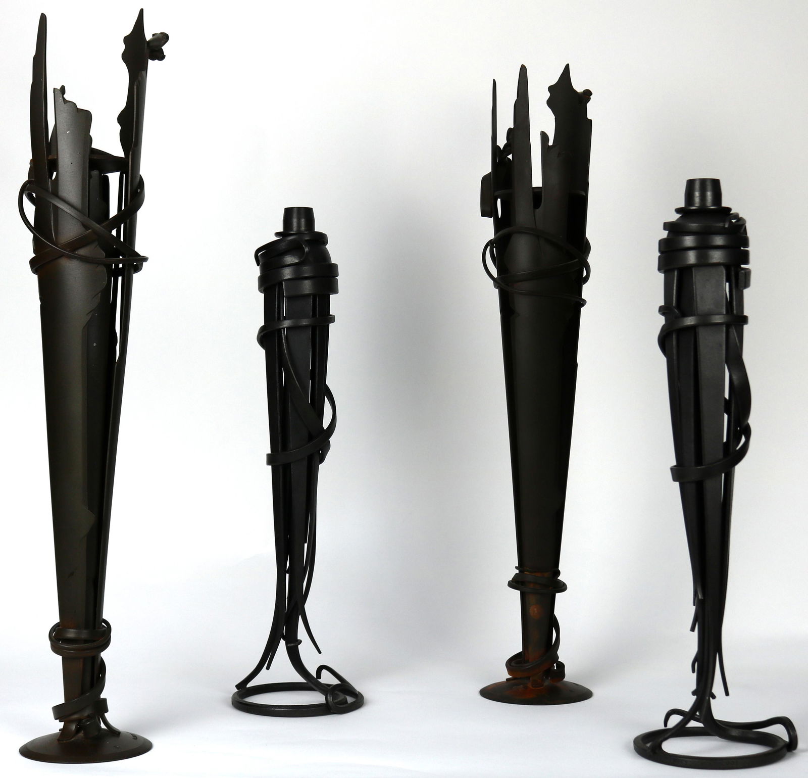 (lot of 4) Two pairs of Albert Paley (American: (lot of 4) Two pairs of Albert Paley (American, Born 1944) wrought iron candlesticks, the larger pair marked Albert Paley 1994, underside marked S-36 32 and S-36 33 respectively 20"h, the smaller mark