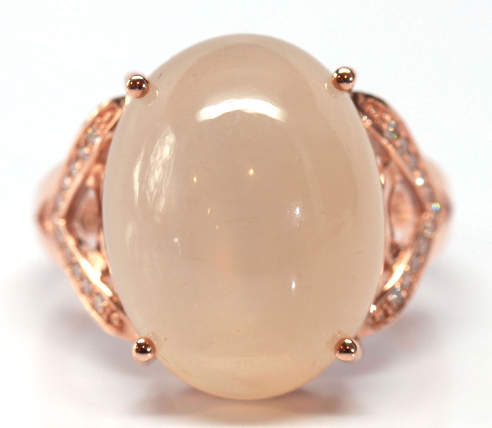 Moonstone, diamond, 14k rose gold ring: Moonstone, diamond, 14k rose gold ring Featuring (1) oval moonstone cabochon, measuring approximately 17.5 X 13.5 X 7.7 mm, flanked by (22) full-cut diamonds, weighing a total of approximately 0.20 ct