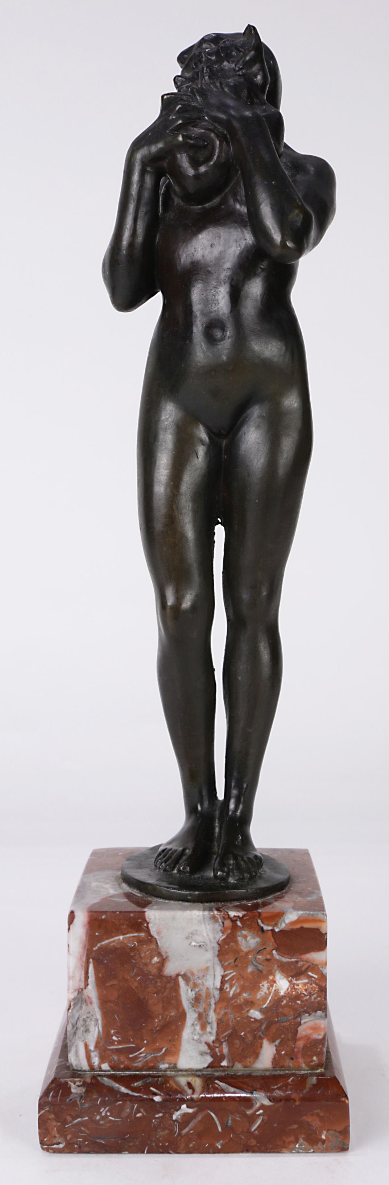 A French Art Nouveau style patinated bronze sculpture: French Art Nouveau style patinated bronze sculpture of a nude young woman holding a cat to her cheek, and rising on a marble plinth, overall: 14"h