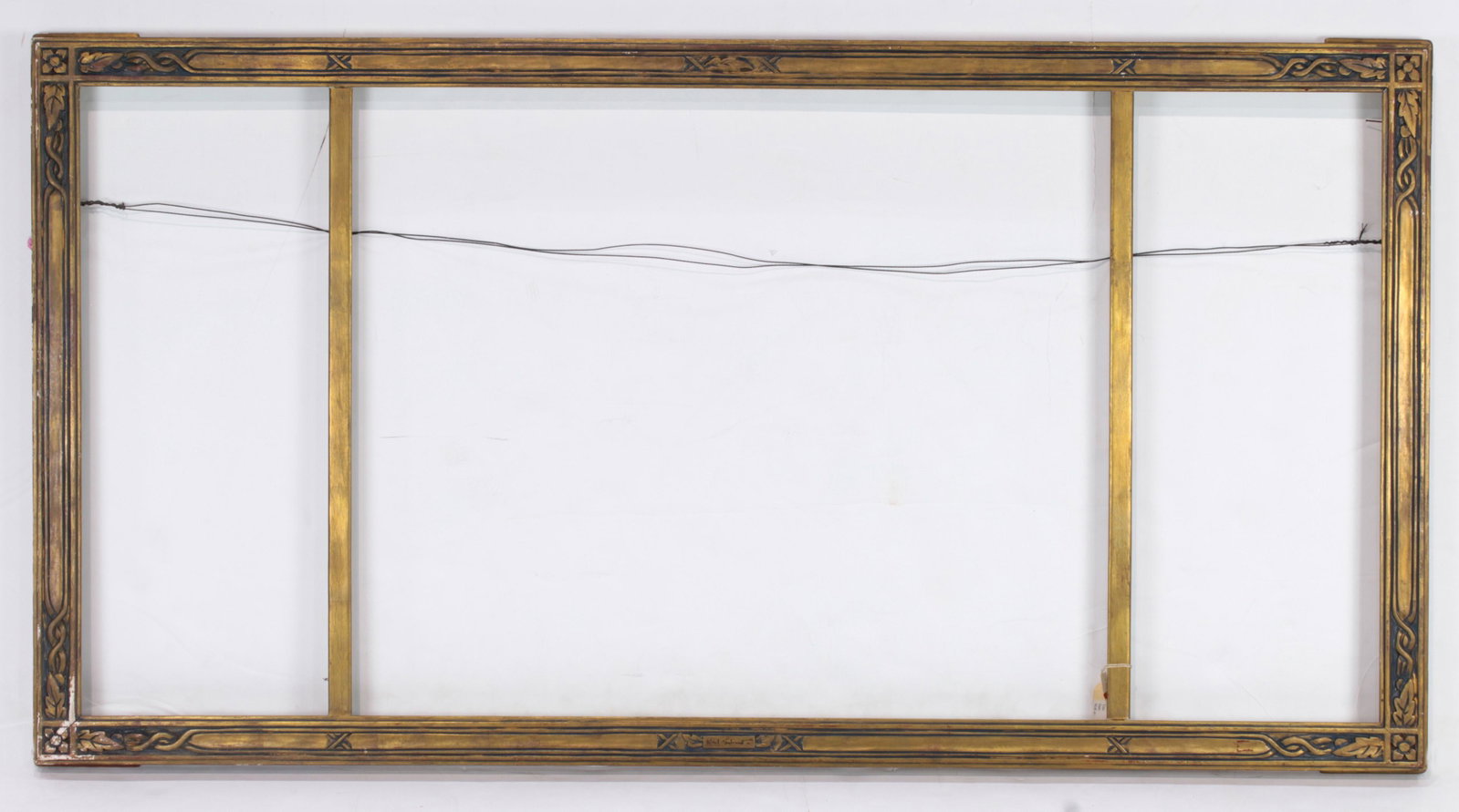 A hand carved Arts and Crafts triptych frame executed: A hand carved Arts and Crafts triptych frame executed by Karl Schmidt (American 1890-1962), executed in three parts, and signed at center bottom, overall 29"h x 56"w the sides rabbet 25"h x 10"w, cent