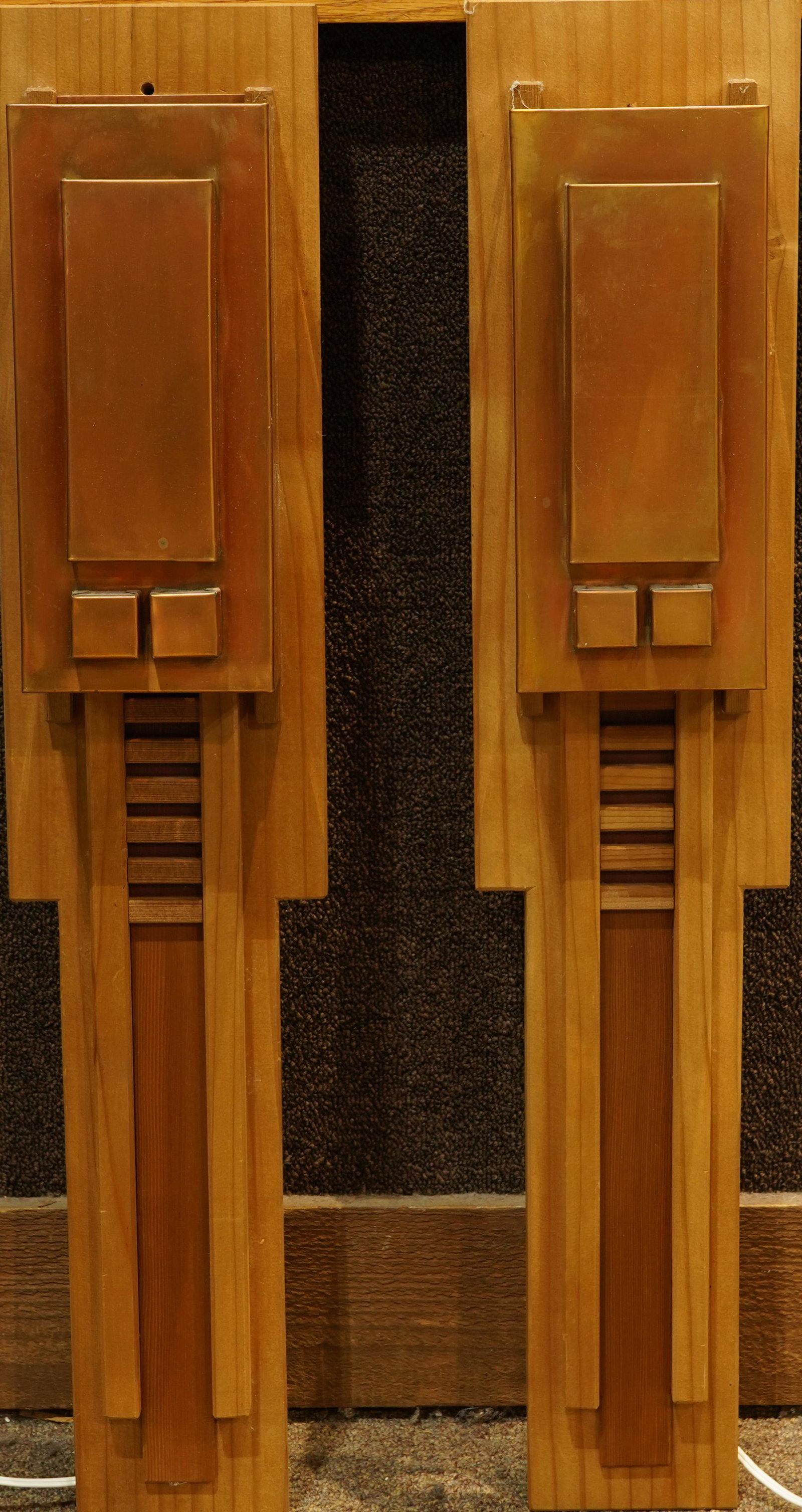 A Pair of Arts and Crafts style wall sconces attributed: A Pair of Arts and Crafts style wall sconces attributed to Berkeley Mills in the Prarie taste, having a geometric copper shade above the conforming support, 31.5"h x 6.5"w