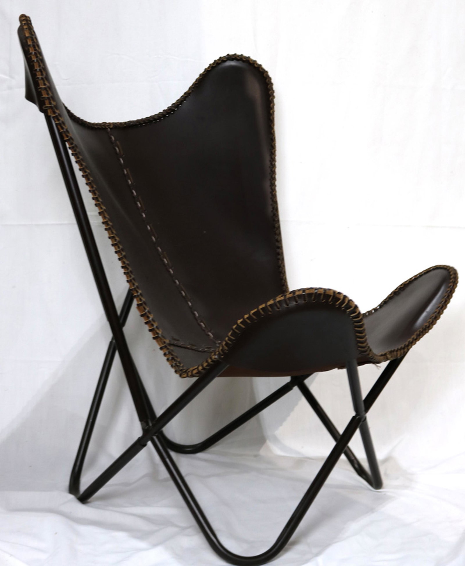 A Knoll style leather Butterfly chair: Knoll style leather Butterfly chair, excuted in brown, and having a black painted metal frame, 35"h