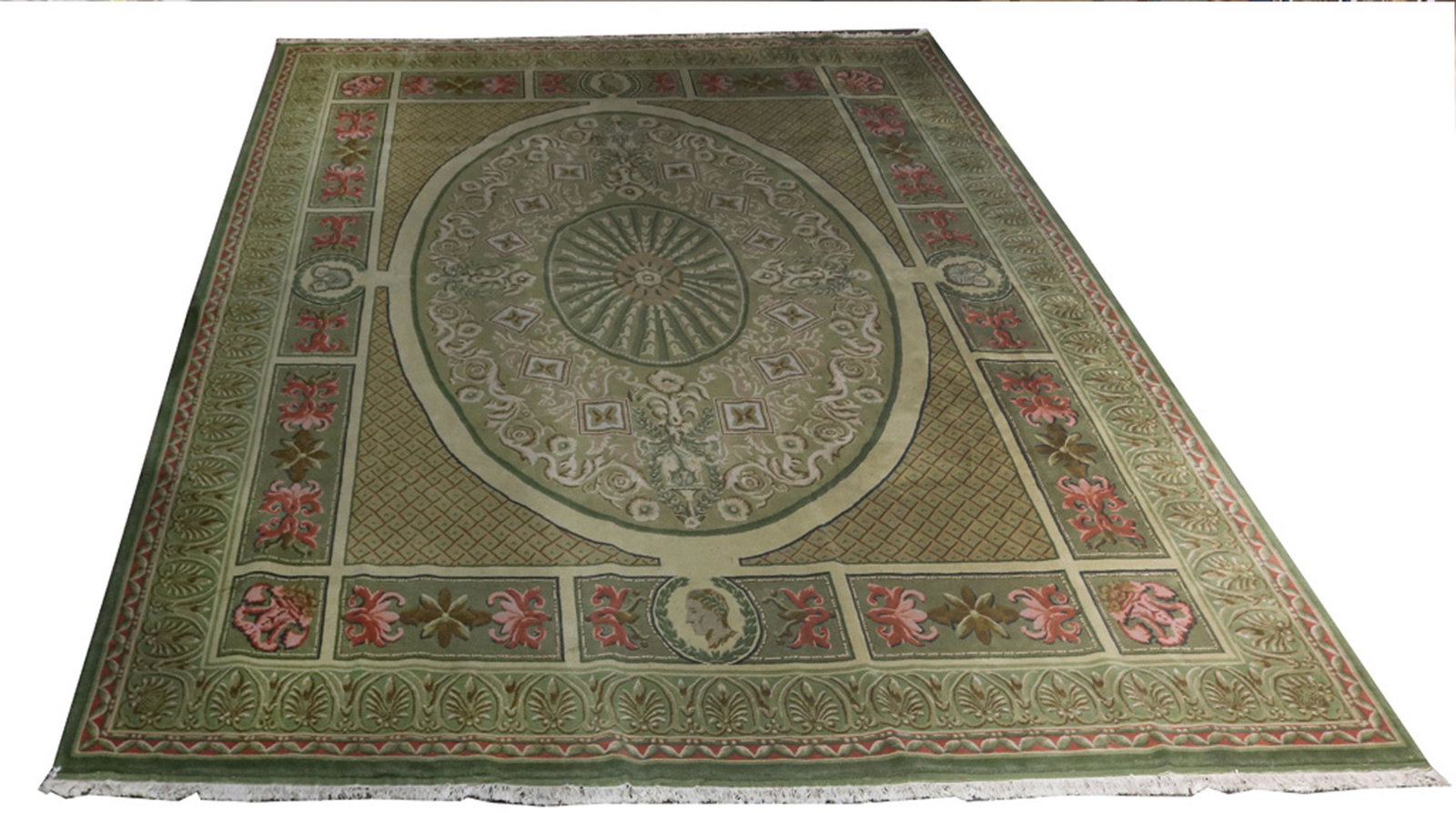 A large custom hand made Tibetan area carpet: A large custom hand made Tibetan area carpet, the large form in the style of a French Aubusson, having an acanthus decorated border surrounding the oval medallion, 15'2" x 11'9"