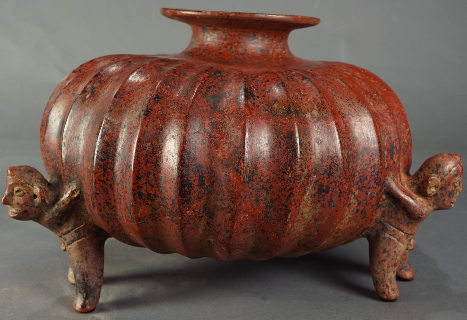 A Pre-Columbian Colima, gourd vessel, Ex Ron Messick: A Pre-Columbian Colima, West Mexico, gourd vessel, 200BC-300AD, the squash form supported by three shaman figures, 10"h Provenance: Ex prominent Woodside CA estate, Ex Ron Messick Fine Arts, Santa Fe 