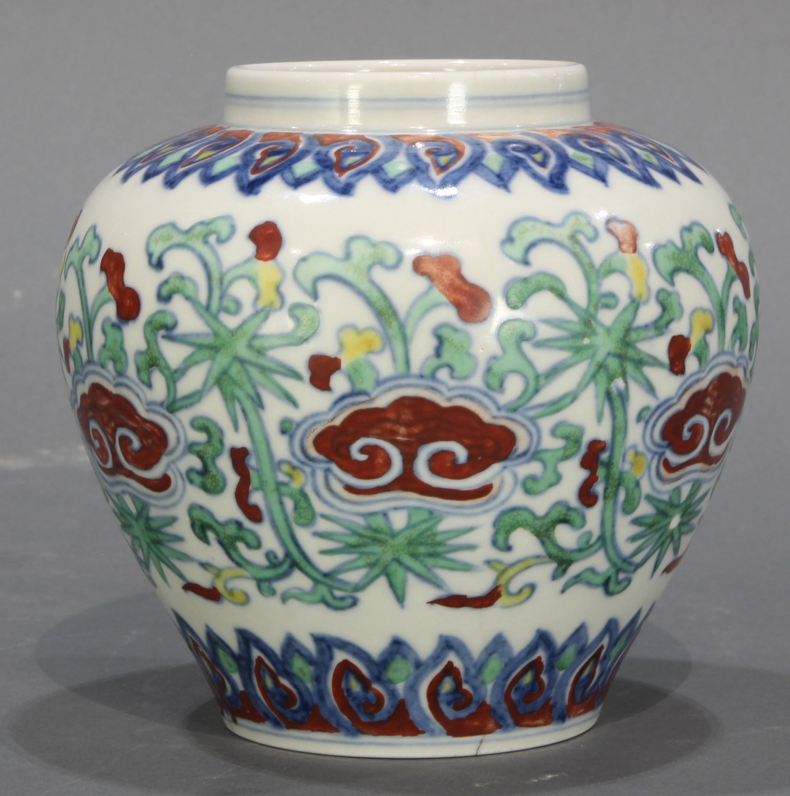 Chinese Doucai 'Floral' Jar: A Chinese Doucai 'Floral' Jar, delicately painted with Ruyi-head, interspersed with flower sprays between bands of overlapping petals, dimensions: 5.5"h x 5.25"w (14cm x 13.3cm). Provenance: Property 
