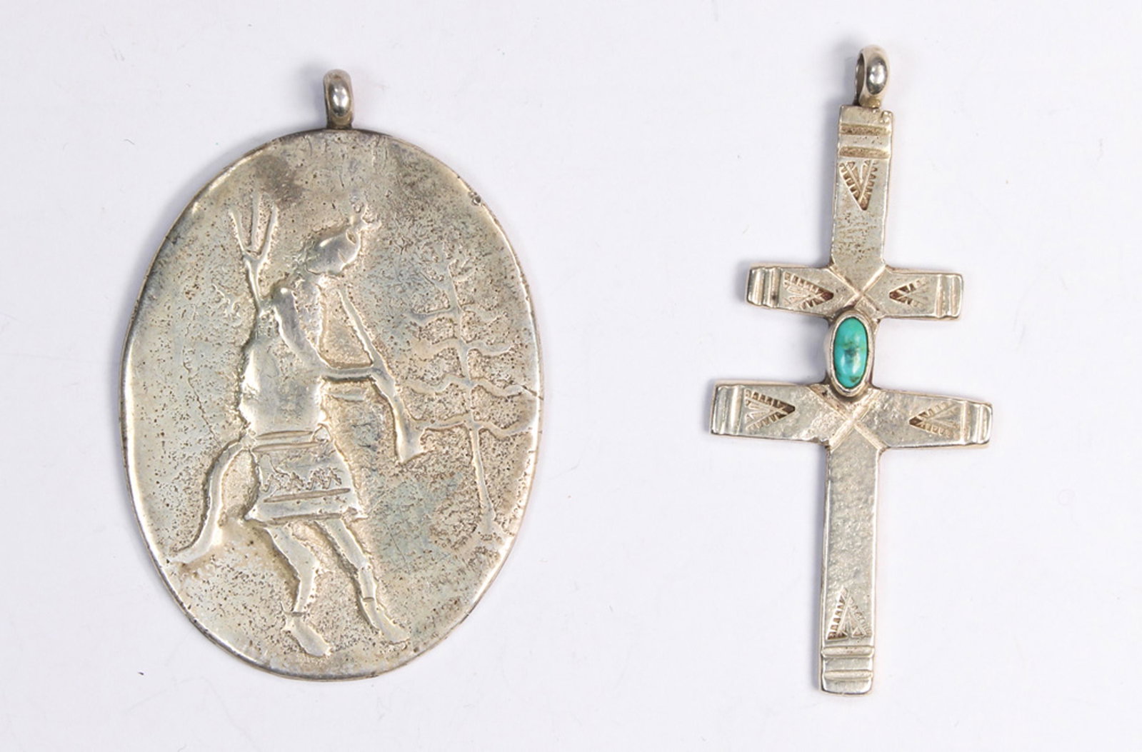 (Lot of 2) Native American Leo Coriz turquoise, silver: (Lot of 2) Native American Leo Coriz turquoise, silver pendants Including 1) turquoise, silver double cross pendant (marked Leo Coriz), measurin approximately 60 mm in length; together with 1) Native 