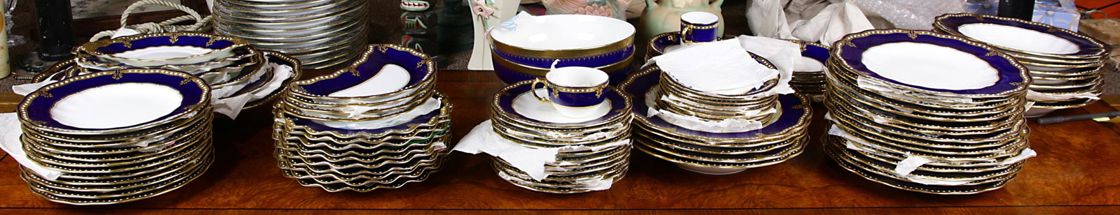 A Royal Crown Derby porelain table service: (lot of 112) A Royal Crown Derby porelain table service, each having a shaped gilt rim with jeweled accents continuing to cobalt banding, consisting of (16) dinner plates 10"dia., (12) luncheon plates