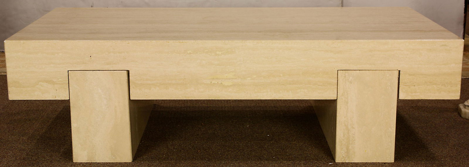 A Modern marble coffee table: A Modern marble coffee table, having a rectangular top above rectangular legs, 16"h x 60"w x 30"d