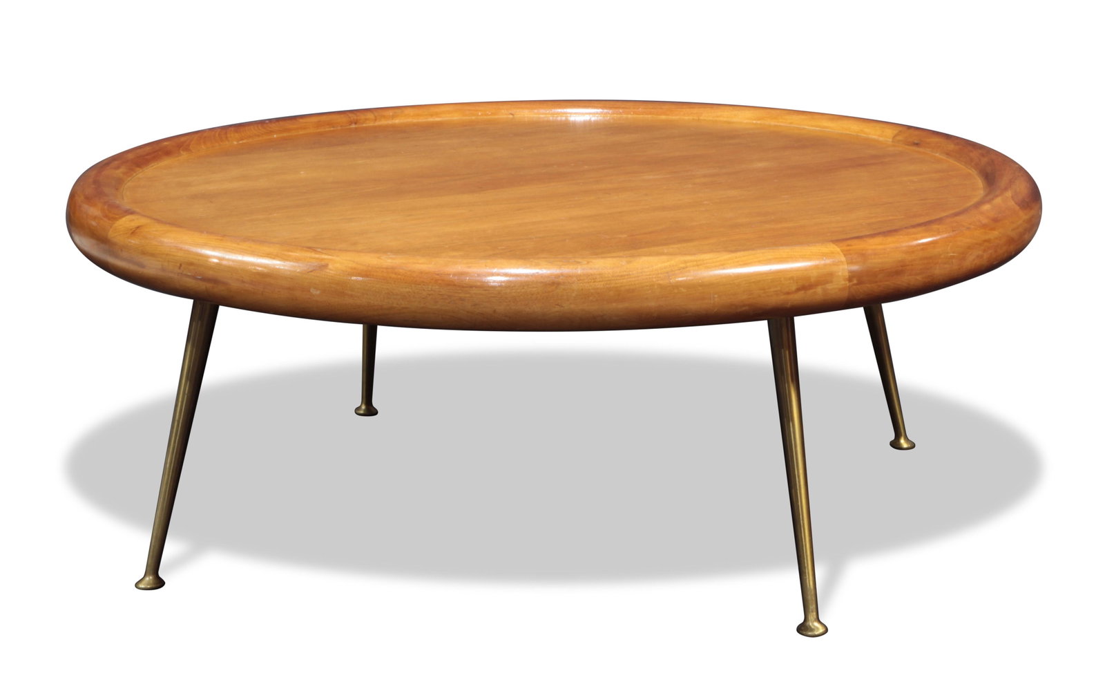 A T.H. Robsjohn-Gibbings (1905-1976) for Widdicomb: T.H. Robsjohn-Gibbings (1905-1976) for Widdicomb coffee table (no. 1784), the circular top executed in bleached walnut, above tapered brass legs, with decal label to underside, and numbered "10/58," 1