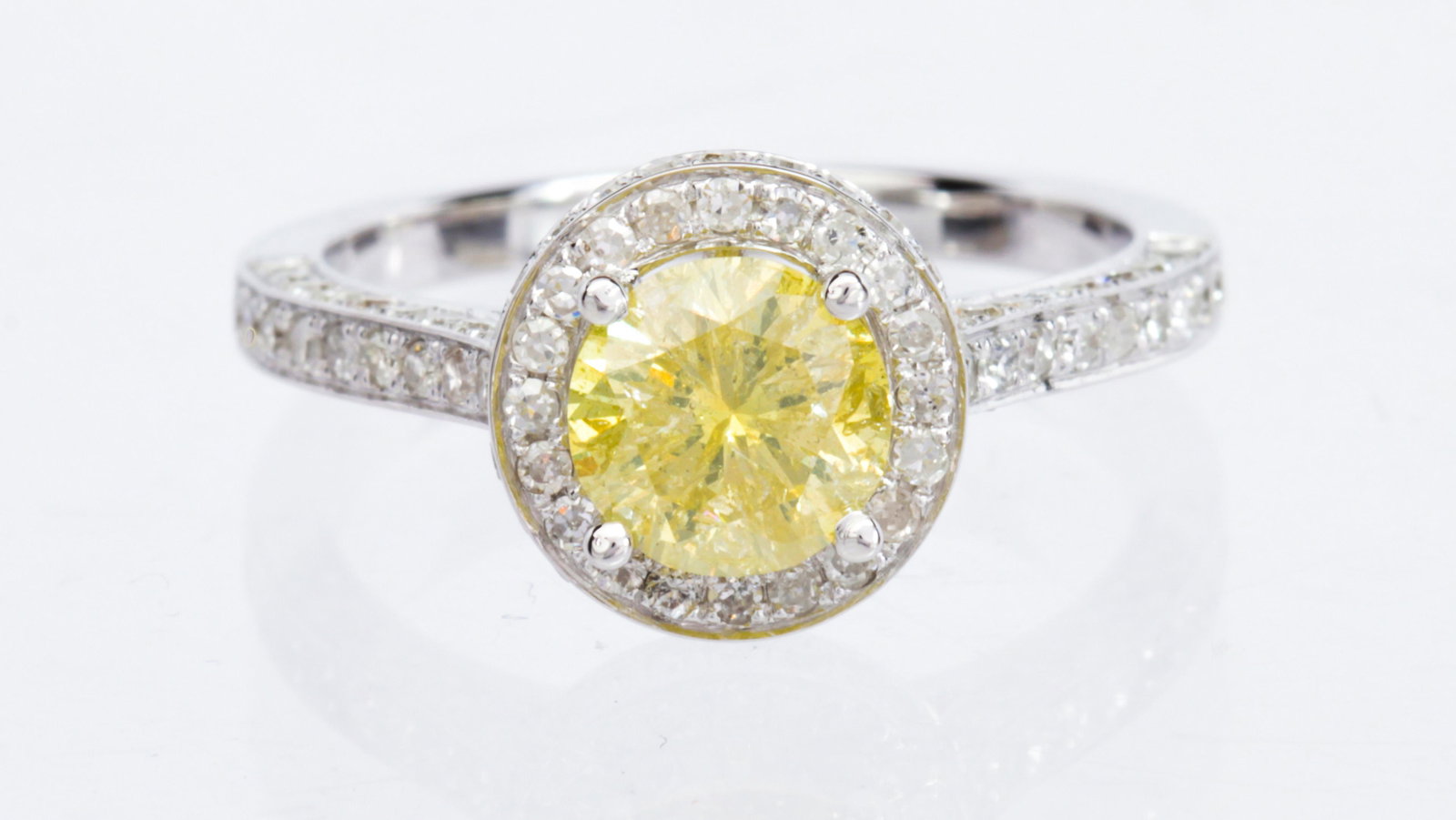 Fancy intense yellow diamond, 18k white gold ring: Fancy intense yellow diamond, 18k white gold ring Centering (1) round brilliant-cut diamond, weighing 1.10 cts., accompanied by a GIA Gemological Natural Colored Diamond Report #2211002497, Dated June