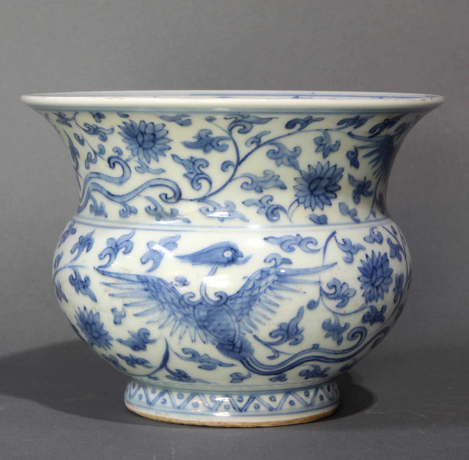 Chinese underglaze blue zhadou: Chinese underglaze blue zhadou, the compressed ovoid form with a wide flaring neck, decorated with phoenix among scrolling lotus leaves, incised with four character Ming Dynasty Zheng De reign mark to