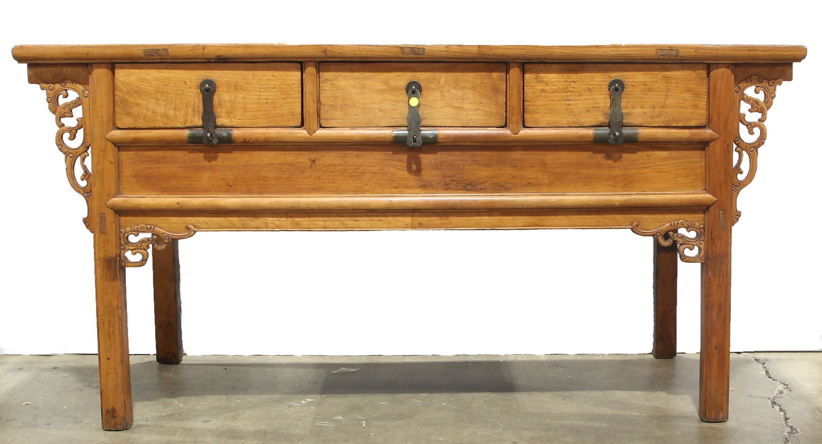 Chinese elm altar coffer table: Chinese elm altar coffer table, the outset crossbanded top, atop twin leafy scrollwork flange supports flanking three side by side drawers with conforming scroll brackets, rising on block legs, 34.5"h