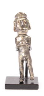 A Peruvian silver figurine: Peruvian silver figurine, 1350-1550AD, the tribal idol standing with feet apart, hands held at chest, with protruding genitals and wearing a headress, 3"h Provenance: Charles Campbell Gallery, San Fra