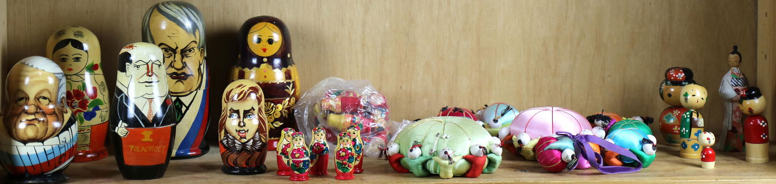 One shelf with Chinese figural silk pincushions (1 of 1)