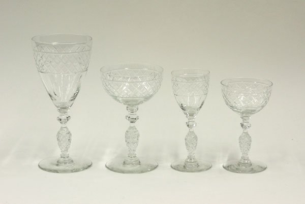 Baccarat crystal stemware set: (lot of 38) Baccarat crystal stemware set, unsigned, etched cross-hatch pineapple patterned bands above finger impression design, comprising eleven wine glasses, six champagnes, ten cordials, and elev