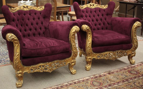 French carved gilt wood bergeres: Pair of French carved gilt wood bergeres, circa 1940, the crest rail and apron decorated with open c-scrolls and rocaille, while the frame is accented by acanthus leaves, resting on trifid feet, uphol
